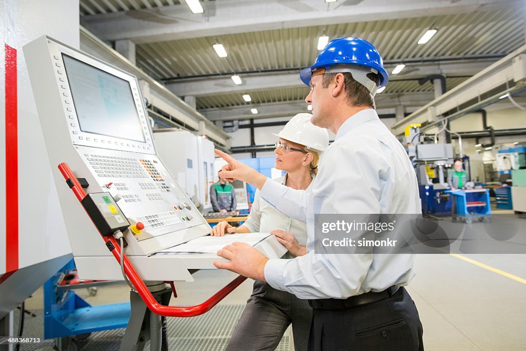Manager And Engineer Programming A CNC