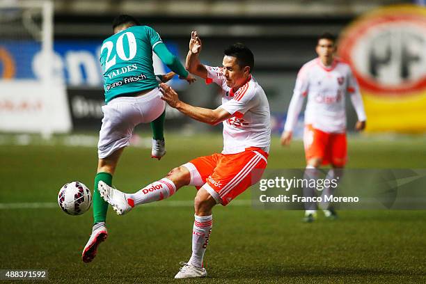 Gustavo Canales of U de Chile fights for the ball with Diego Valdes of Audax Italiano during a match between Audax Italiano and U de Chile as part of...