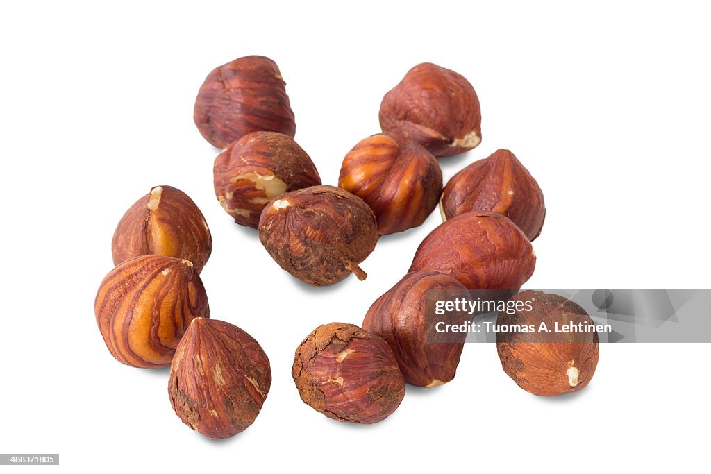 Closeup of several hazelnut peanuts