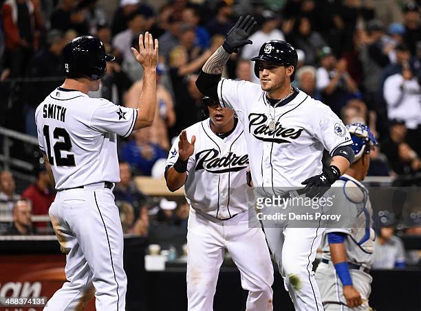 Yasmani Grandal of the San Diego Padres, right, is congratulated by Seth Smith after hitting a three run home run during the sixth inning of a...