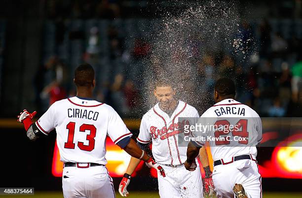 Andrelton Simmons of the Atlanta Braves is doused with liquid after hitting a walk-off RBI single in the ninth inning against the Toronto Blue Jays...