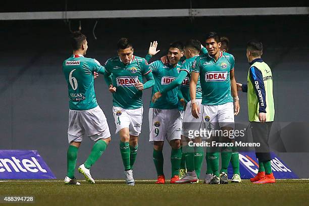 Felipe Mora of Audax Italiano celebrates with teammates after scoring the second goal of his team during a match between Audax Italiano and U de...