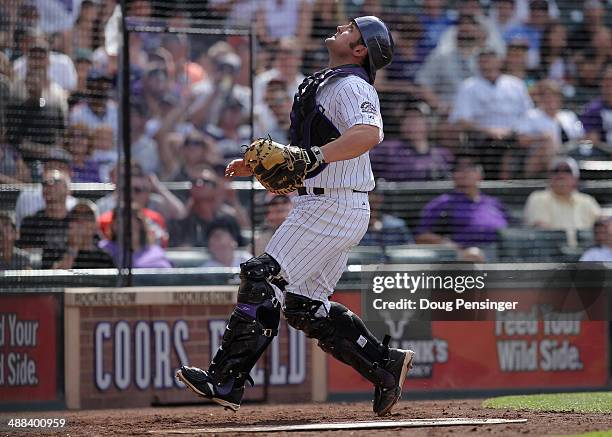Catcher Michael McKenry of the Colorado Rockies tracks a pop foul against the New York Mets at Coors Field on May 4, 2014 in Denver, Colorado. The...