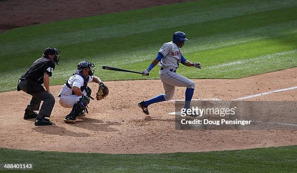 Curtis Granderson of the New York Mets takes an at bat as catcher Michael McKenry of the Colorado Rockies baks up the plate and umpire Paul Schrieber...