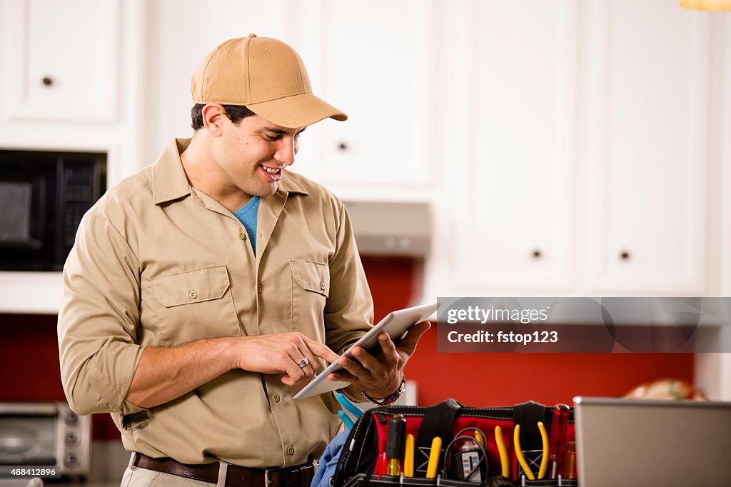 Service Industry:  Repairman working at customer's home. Tools. Digital tablet.