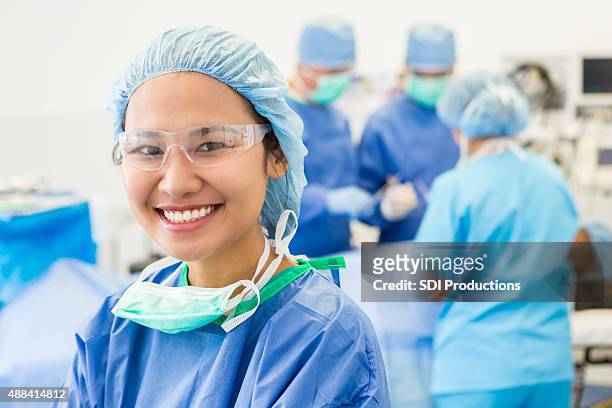 surgical intern or nurse in hospital or during operation - operatiekamer stockfoto's en -beelden