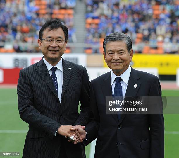 Saburo Kawabuchi,the first chairman of J.League and Mitsuru Murai,the fifth chairman of J.league shake hands prior to the J.League match between...