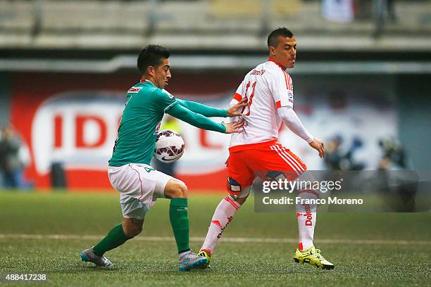 Sebastian Ubilla of U de Chile fights for the ball with Juan Cornejo of Audax Italiano during a match between Audax Italiano and U de Chile as part...