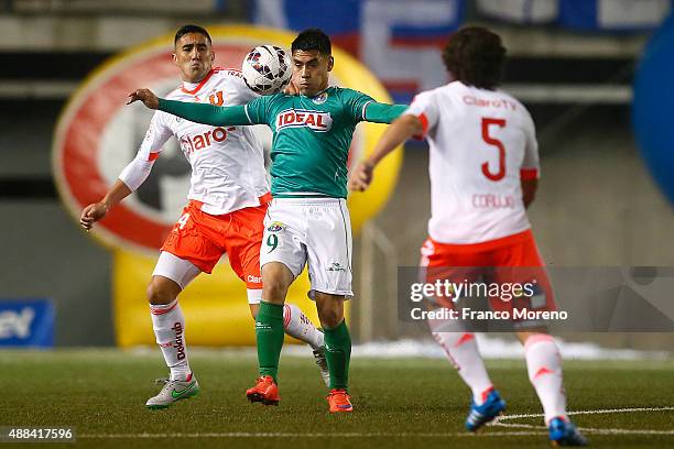 Osvaldo Gonzalez of U de Chile fights for the ball with Felipe Mora of Audax Italiano during a match between Audax Italiano and U de Chile as part of...