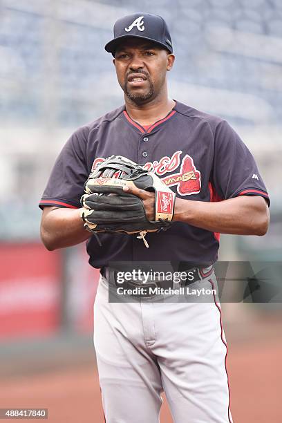 Third base coach Bo Porter of the Atlanta Braves plays catch before a baseball game against the Washington Nationals at Nationals Park on September...