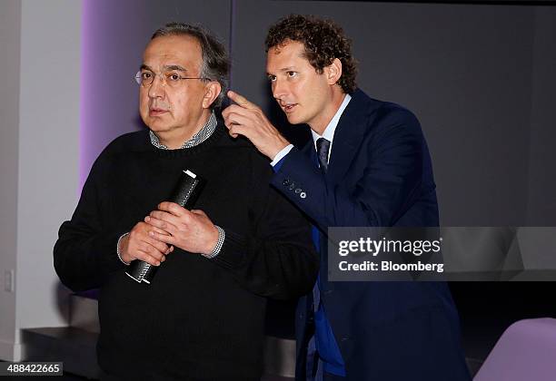 Sergio Marchionne, chief executive officer of Fiat SpA and Chrysler Group LLC, left, speaks with John Elkann, chairman of Fiat SpA at Chrysler Group...