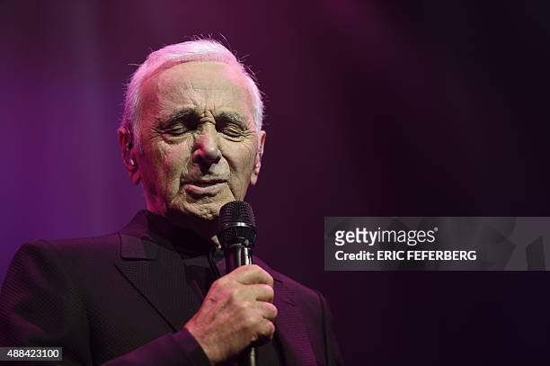 French singer Charles Aznavour performs on stage at the Palais des Sports in Paris on September 15, 2015 in Paris. AFP PHOTO / ERIC FEFERBERG