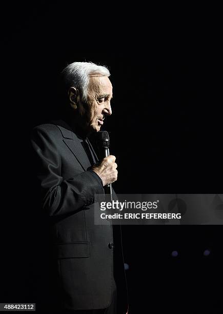 French singer Charles Aznavour performs on stage at the Palais des Sports in Paris on September 15, 2015 à Paris. AFP PHOTO / ERIC FEFERBERG