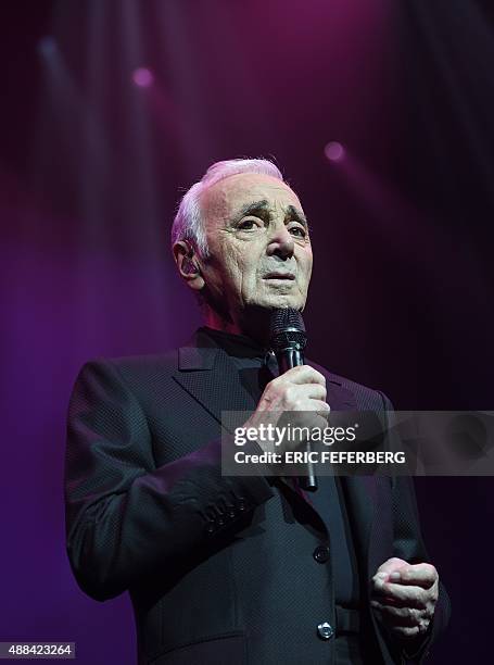 French singer Charles Aznavour performs on stage at the Palais des Sports in Paris on September 15, 2015 à Paris. AFP PHOTO / ERIC FEFERBERG