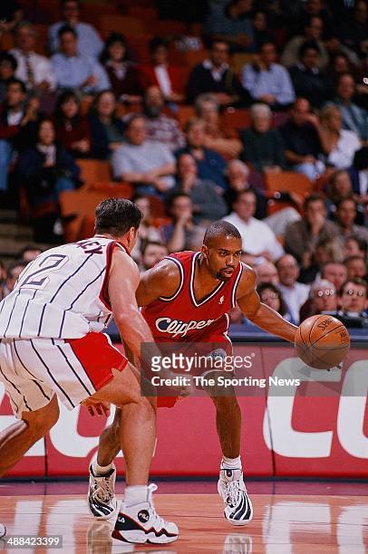 Darrick Martin of the Los Angeles Clippers moves the ball against Matt Maloney of the Houston Rockets during the game on January 27, 1998 at Compaq...