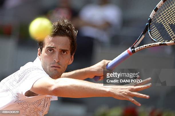 Spanish player Albert Ramos returns the ball to Spanish player David Ferrer during their men's singles second round tennis match of the Madrid...