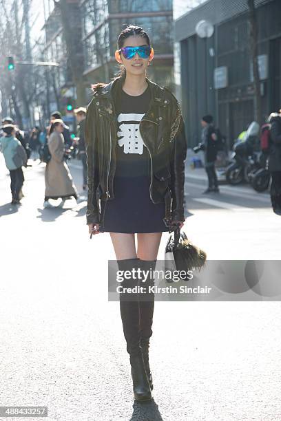 Model Ming Xi wears a vintage Harley Davidson jacket, Fendi Monster Pom Pom and bag and Phillip Lim sunglasses on day 6 of Paris Collections: Women...