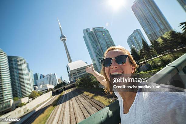 woman traveling taking selfie portrait in toronto - toronto stock pictures, royalty-free photos & images