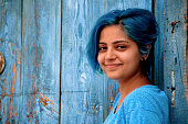 blue-haired young girl smiles