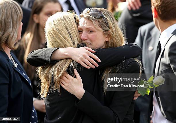 Mourners gather to pay their respects before the cortege passes by following the repatriation of five British servicemen who were killed in a...