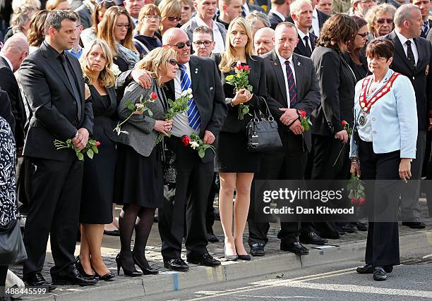 Mourners gather to pay their respects as the cortege passes by following the repatriation of five British servicemen who were killed in a helicopter...