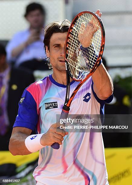 Spanish player David Ferrer celebrates after winning his men's singles second round tennis match against Spanish player Albert Ramos at the Madrid...