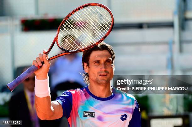 Spanish player David Ferrer celebrates after winning his men's singles second round tennis match against Spanish player Albert Ramos at the Madrid...