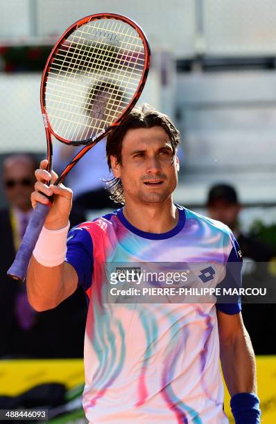 Spanish player David Ferrer celebrates after winning his men's singles second round tennis match against Spanish player Albert Ramos at the Madrid...