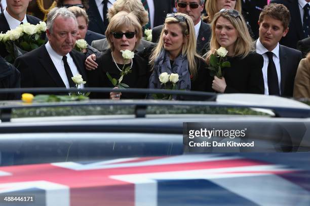 Mourners gather to pay their respects as the cortege passes by following the repatriation of five British servicemen who were killed in a helicopter...