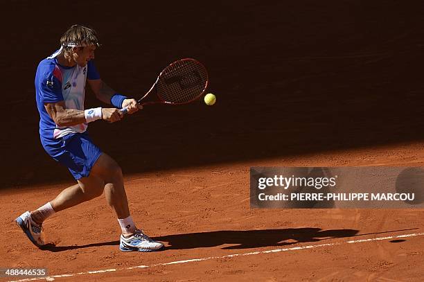 Spanish player David Ferrer returns the ball to Spanish player Albert Ramos during their men's singles second round tennis match of the Madrid...