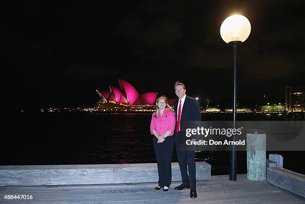 Nurse Elaine Arnold and Glen McGrath stand in front of the Sydney Opera House, with its sails turned pink to commemorate ten years of placing McGrath...