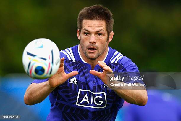Richie McCaw of the All Blacks takes a pass during a New Zealand All Blacks training session at Lensbury on September 16, 2015 in London, United...