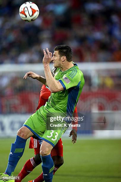 Kenny Cooper of Seattle Sounders FC heads the ball against FC Dallas at Toyota Stadium on April 12, 2014 in Frisco, Texas.