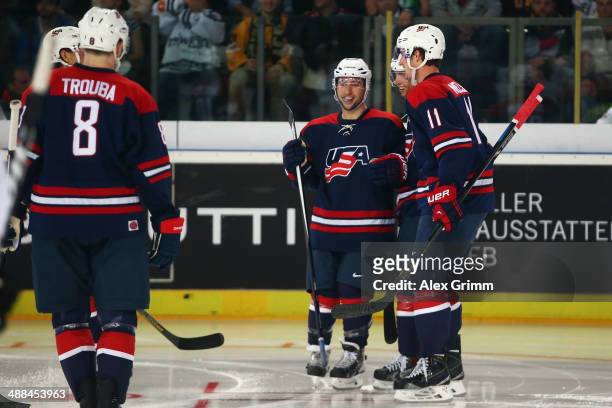 Tyler Johnson of USA celebrates his team's third goal with team mates during the international ice hockey friendly match between Germany and USA at...
