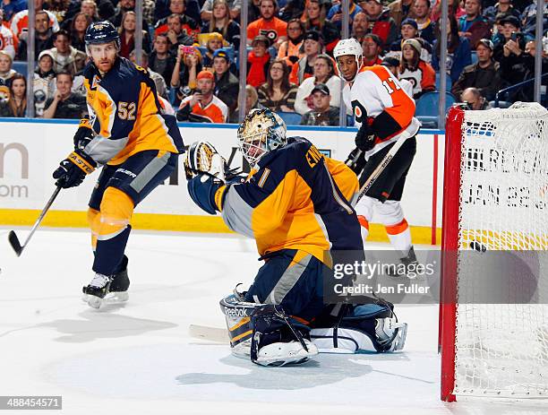 Jhonas Enroth and Alexander Sulzer of the Buffalo Sabres defend the net against of the Philadelphia Flyers as the Flyers score a goal on January 14,...
