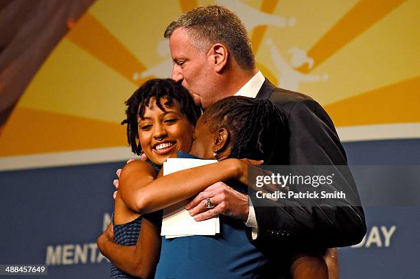 New York City Mayor Bill de Blasio and his wife, Chirlane McCray hug their daughter, Chiara de Blasio , before she received a special recognition...