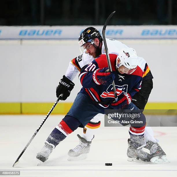 Tyler Johnson of USA is challenged by Constantin Braun of Germany during the international ice hockey friendly match between Germany and USA at Arena...