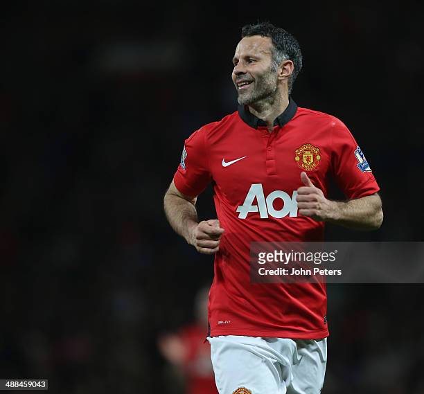 Interim Manager Ryan Giggs of Manchester United smiles after taking a free kick during the Barclays Premier League match between Manchester United...