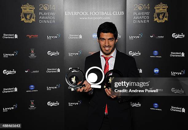 Luis Suarez of Liverpool who poses with Fans Player of the Year award, Goal of the season award and Players Player of the Year award during the...