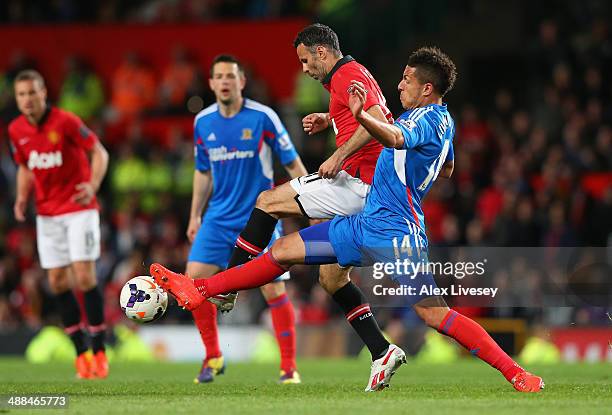 Manchester United Caretaker Manager Ryan Giggs competes with Jake Livermore of Hull City during the Barclays Premier League match between Manchester...