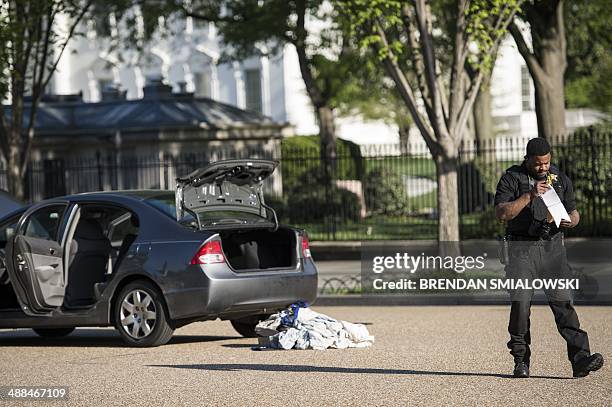 Member of the Secret Service walks from a car on Pennsylvania Avenue in front of the White House May 6, 2014 in Washington, DC. The area was locked...