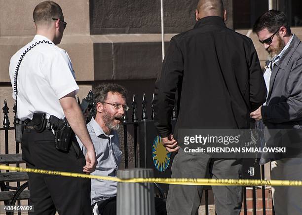Man who was later taken into custody speak with law enforcement on Pennsylvania Avenue near the White House May 6, 2014 in Washington, DC. The area...