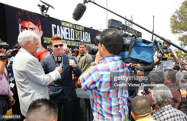 Boxer Canelo Alvarez and Oscar De La Hoya , president of Golden Boy Promotions, speak with different members of the media during the press conference...