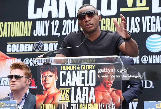 Boxer Erislandy Lara speaks onstage as fellow boxer Canelo Alvarez looks on during the press tour for Canelo Alvarez v Erislandy Lara on May 6, 2014...