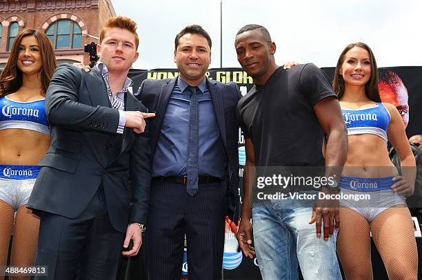 Boxers Canelo Alvarez and Erislandy Lara and Oscar De La Hoya , president of Golden Boy Promotions, pose onstage during the press conference for...