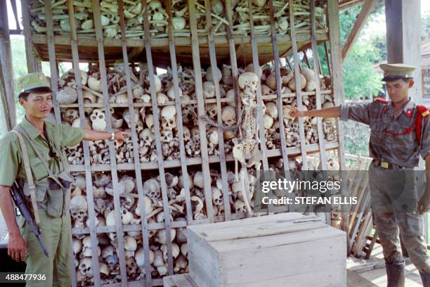 Cambodian soldiers point to skeletons of about 3 000 victims of the genocide perpetrated by the Khmer Rouge during their 1975-78 reign in Cambodia,...