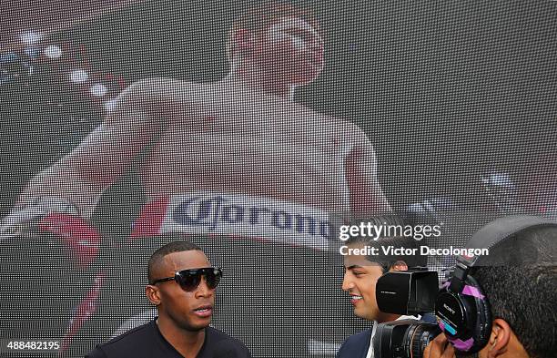 Boxer Erislandy Lara speaks with the media in front of a video board displaying an image of Canelo Alvarez after the press conference for Canelo...