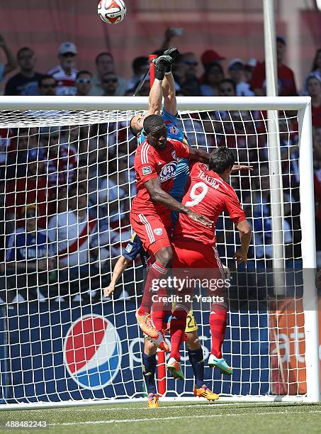 Hendry Thomas and David Texeira of FC Dallas jump to defend the ball against Luis Robles of New York Red Bulls at Toyota Stadium in Frisco on May 4,...