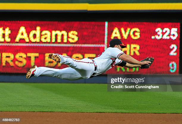 Dan Uggla of the Atlanta Braves makes a diving stop of a 4th inning ground ball against the St. Louis Cardinals at Turner Field on May 6, 2014 in...