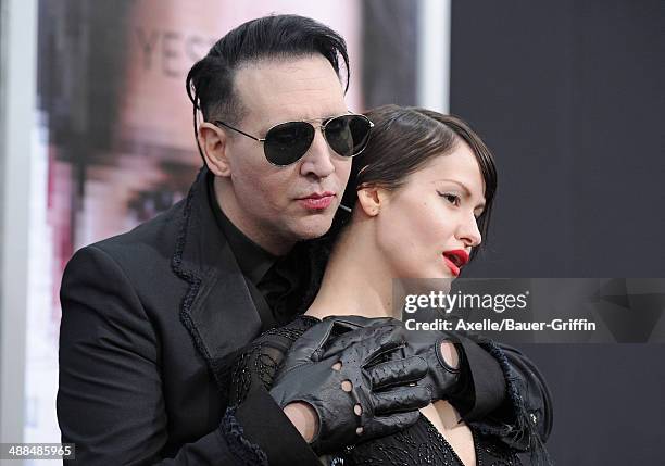 Musician Marilyn Manson and Lindsay Usich arrive at the Los Angeles premiere of 'Transcendence' at Regency Village Theatre on April 10, 2014 in...